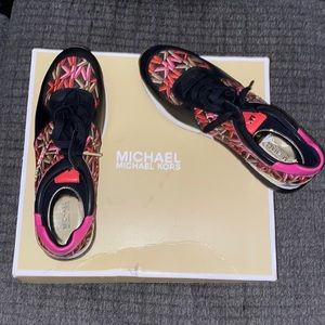 Michael Kors pink and black tennis shoes.